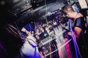 Djs Supre and Siconix on the stage with a crowd in the background