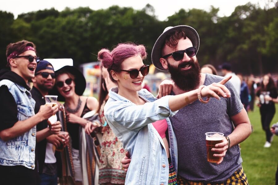 Festival goers pointing in the distance