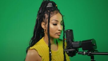 Shenseea in front of a microphone