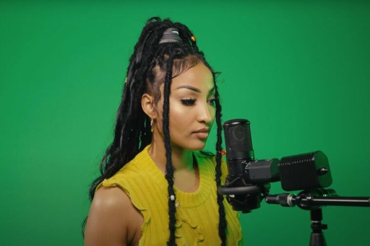 Shenseea in front of a microphone