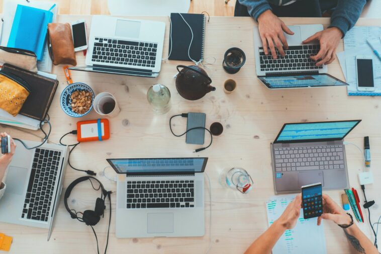 View above a communal table with people working on laptops