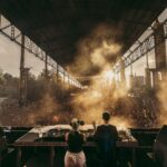 DJs playing at Kappa Futur in 2024 with light shining through clouds of smoke.