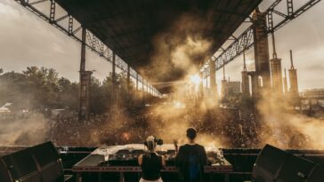 DJs playing at Kappa Futur in 2024 with light shining through clouds of smoke.