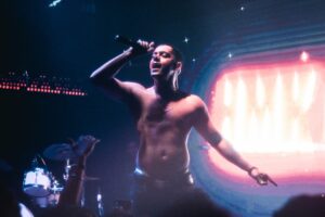 Hanumankind singing on stage shirtless.