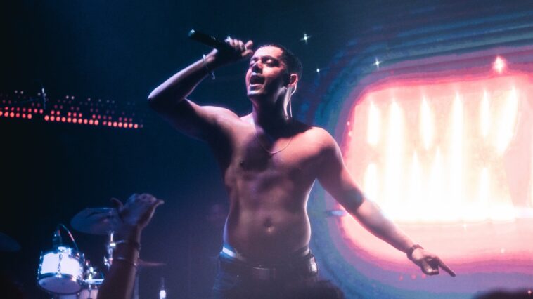 Hanumankind singing on stage shirtless.