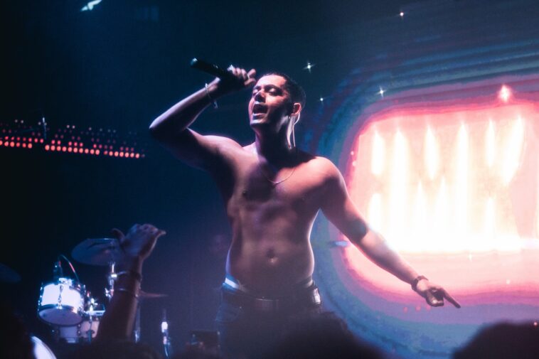 Hanumankind singing on stage shirtless.