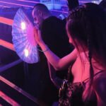 woman with braids fighting lazers at a festival