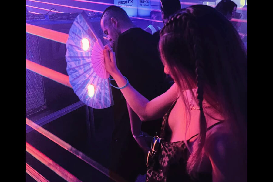 woman with braids fighting lazers at a festival