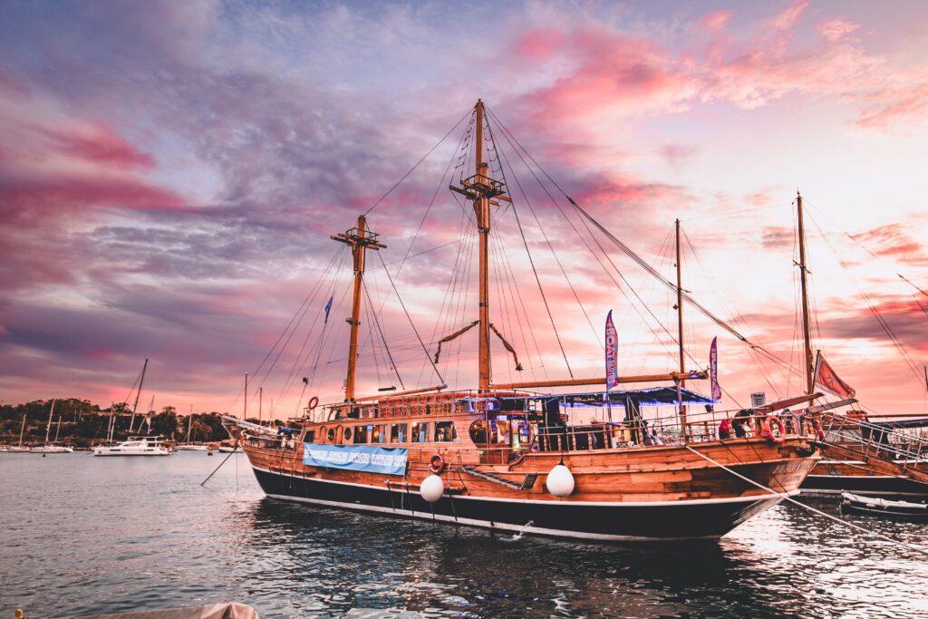 Boat with a purple and orange sunset sky in the background.