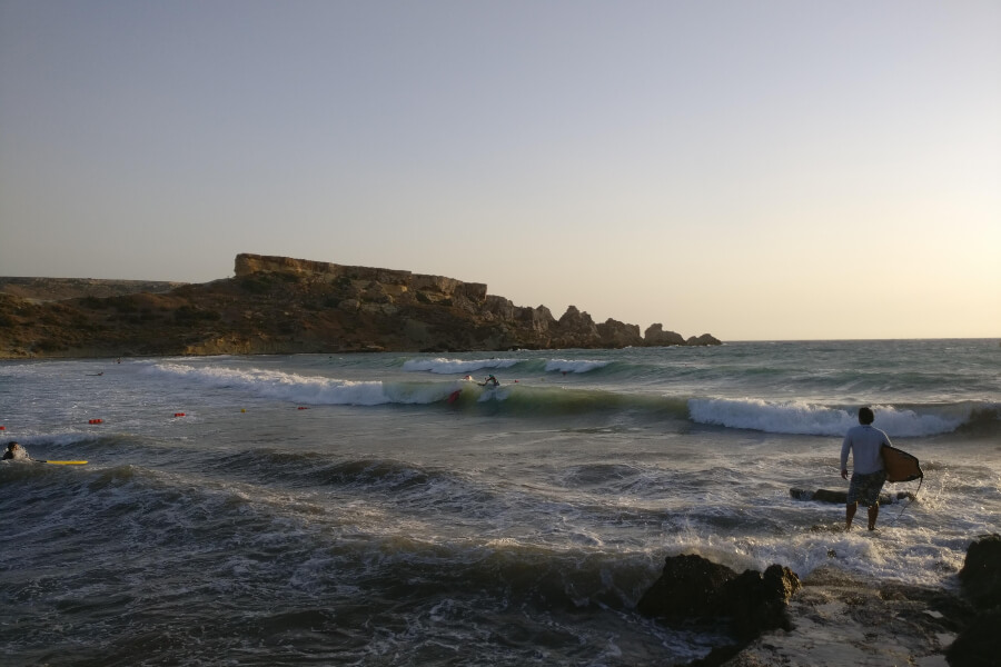 Surfer looking out at sea