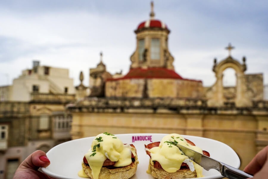 poached egg on bagel overlooking valletta