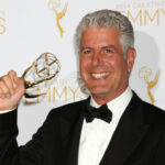 Photo of Anthony Bourdain in a tux holding a grammy award.