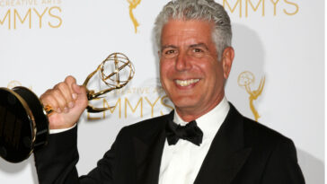 Photo of Anthony Bourdain in a tux holding a grammy award.