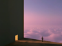 Personal on ledge overlooking a purple sky