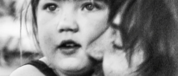 Father hugging girl in black and white