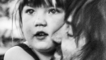 Father hugging girl in black and white