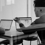 Black and white image of people working in a conference room.